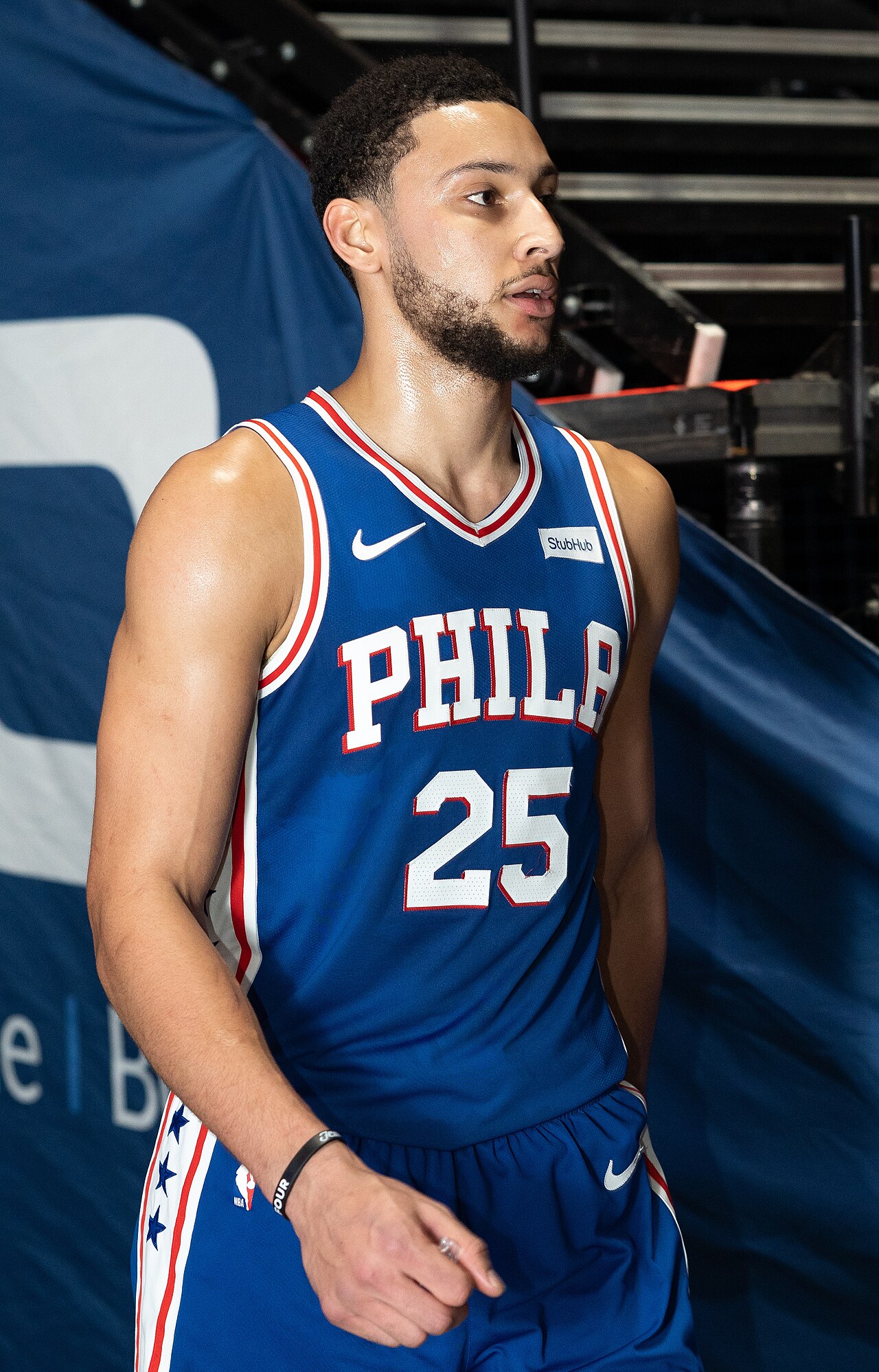 Ben Simmons in an NBA game, looking upcourt with the ball