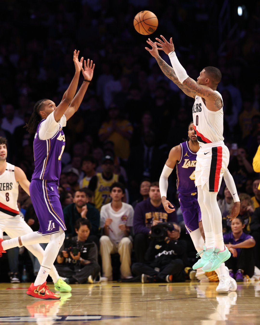A Trail Blazers player shoots over the Lakers