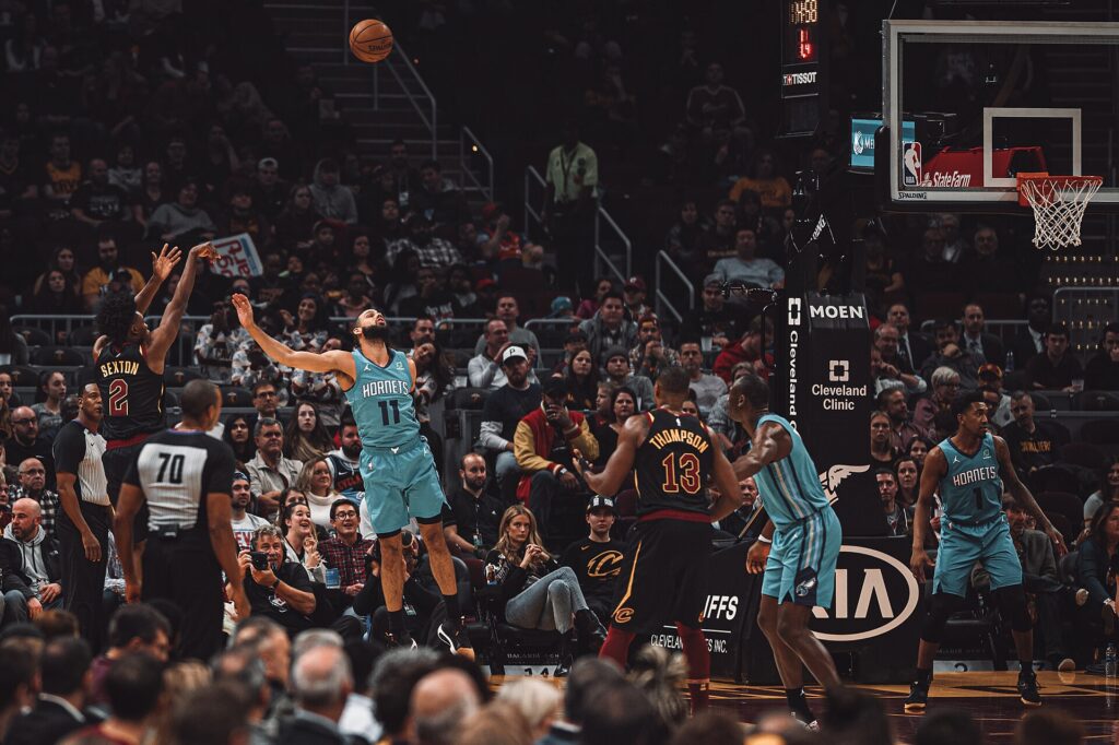 Collin Sexton of the Cavaliers shoots a jump shot against the Hornets in front of a full crowd in Cleveland