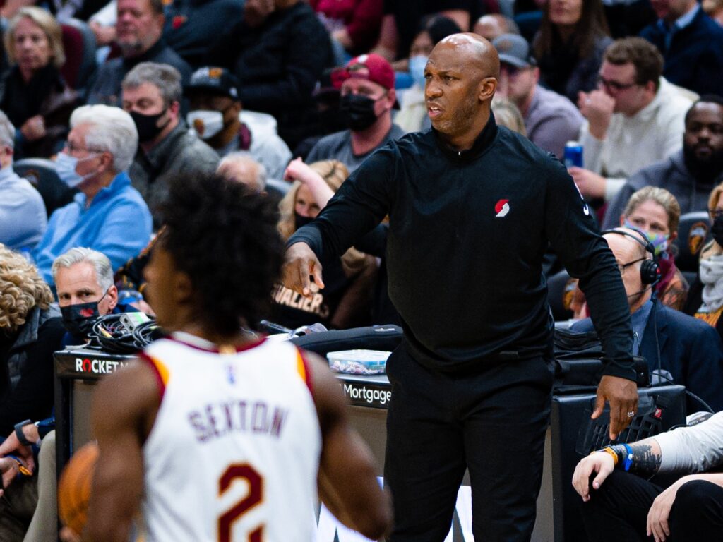 Chauncey Billups in a black Trail Blazers shirt gesturing on the sideline during a game in Cleveland