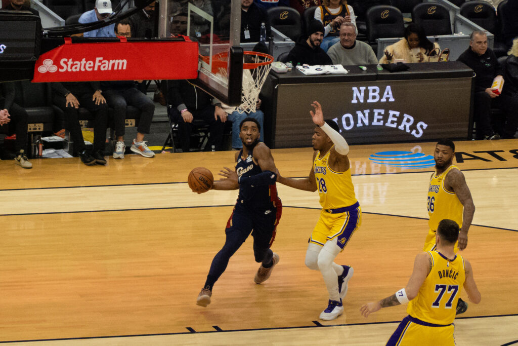 Donovan Mitchell in a dark Cleveland uniform drives toward the basket against the Lakers on January 28, 2026.