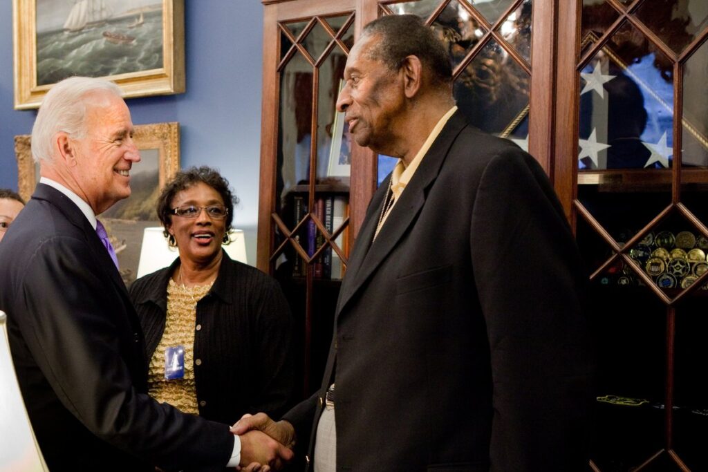 Earl Lloyd, the first Black player in an NBA game, shaking hands during a 2010 visit to the White House