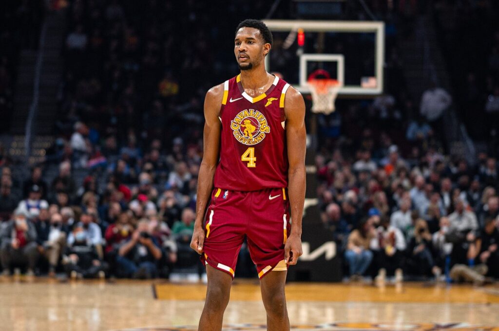 Evan Mobley in a wine-colored Cavaliers uniform standing on the court during a game