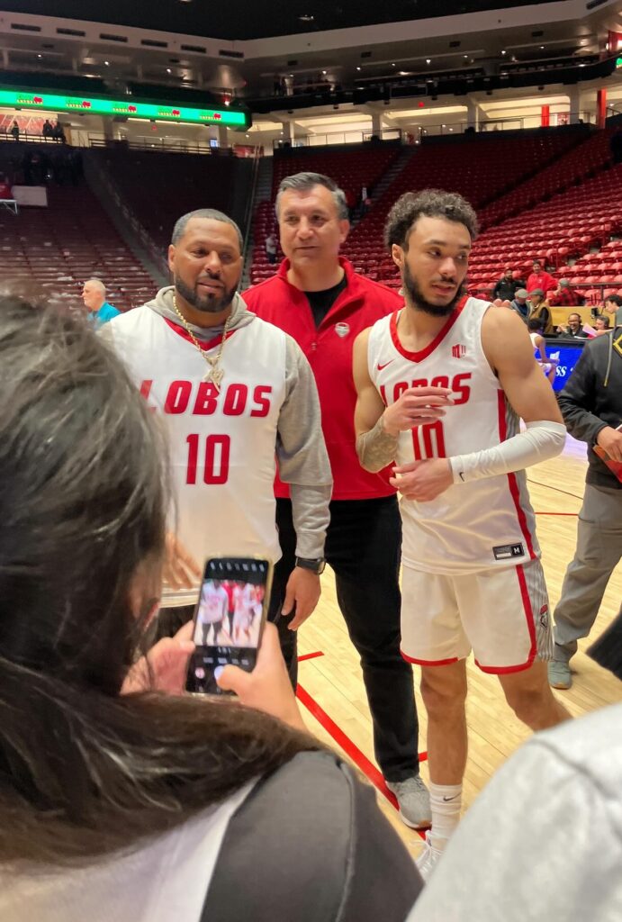 Jaelen House at right in a white New Mexico Lobos No. 10 uniform in March 2024