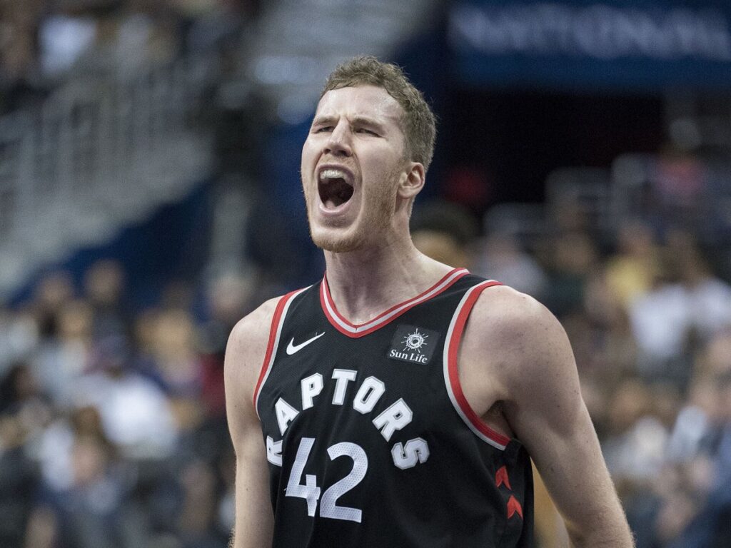 Jakob Poeltl shouts in a black Toronto Raptors No. 42 jersey during a game