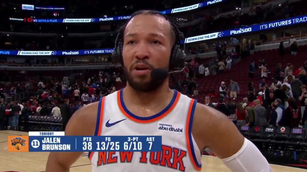 Jalen Brunson in a Knicks jersey and headset during an on-court postgame interview in Chicago