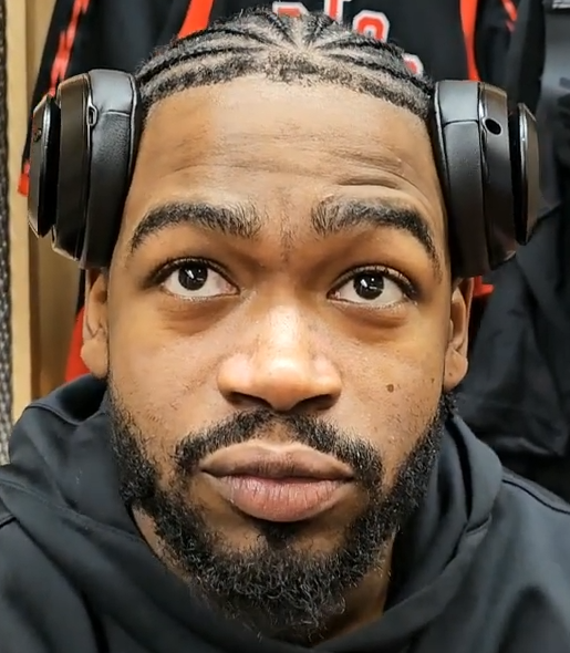 Jamal Shead wearing headphones during a 2025 locker-room interview