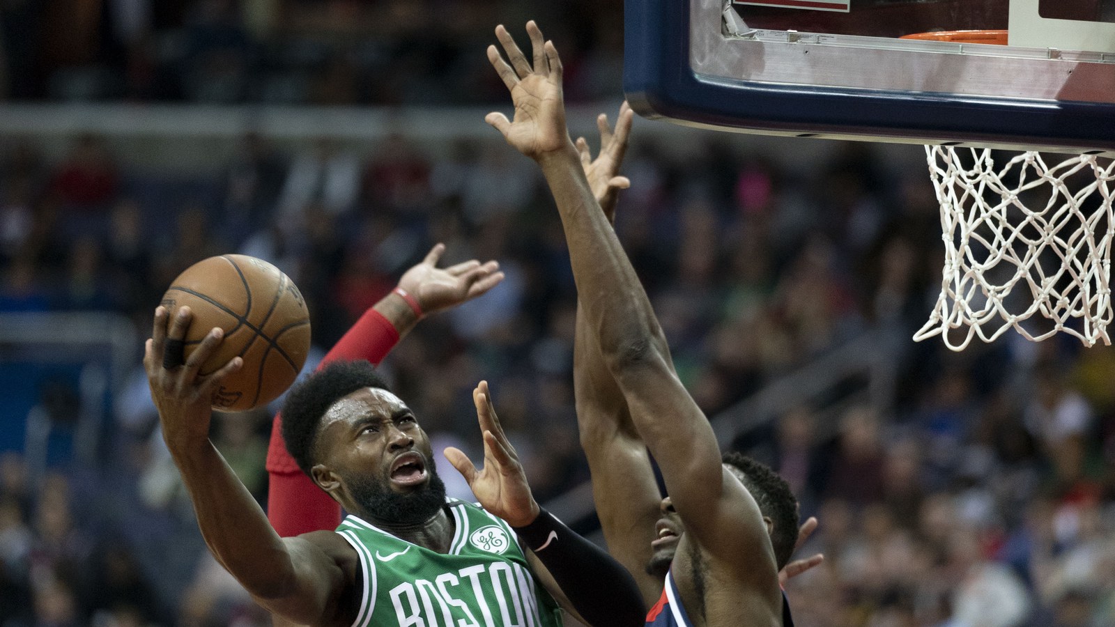 Jaylen Brown in a Boston Celtics jersey drives to the basket against the Washington Wizards