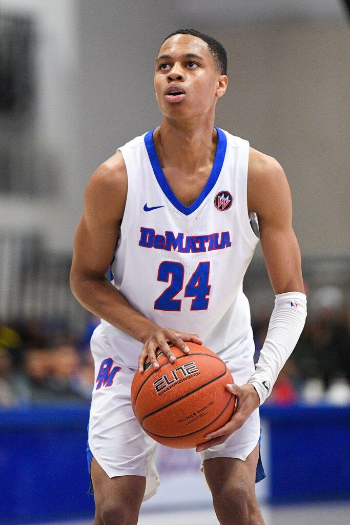 Jordan Hawkins holds a basketball in a DeMatha number 24 jersey in February 2020.