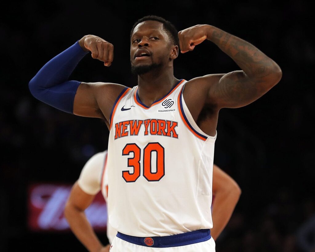 Julius Randle flexes in a white New York Knicks No. 30 jersey