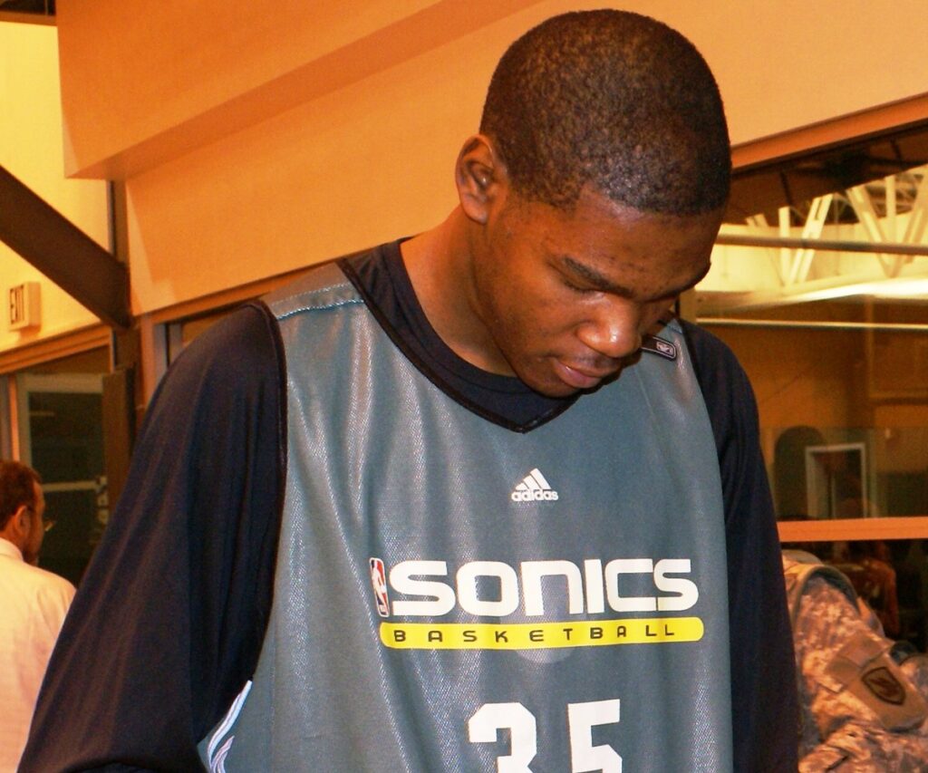 Seattle SuperSonics rookie Kevin Durant signs a basketball at the Sonics practice facility in January 2008