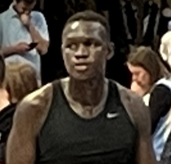 Khaman Maluach in a black warmup shirt before a college game