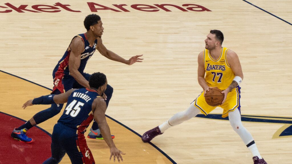 Luka Doncic of the Los Angeles Lakers holds the ball against Cleveland Cavaliers defenders in January 2026