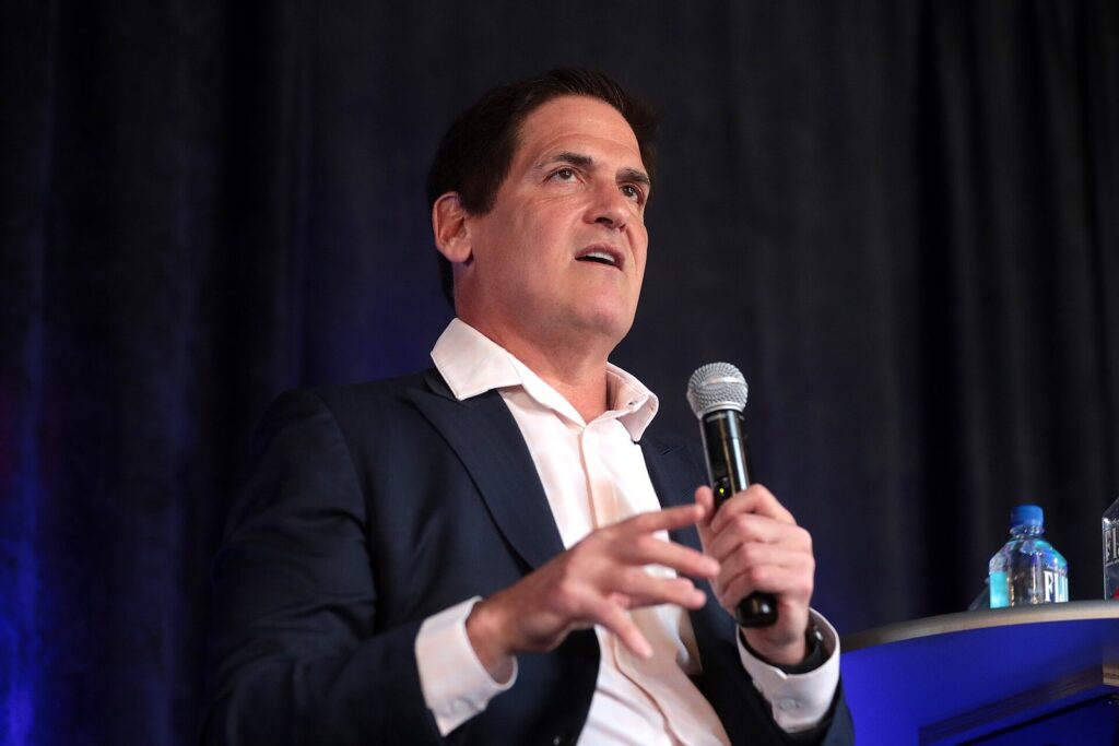Mark Cuban speaks into a microphone on stage