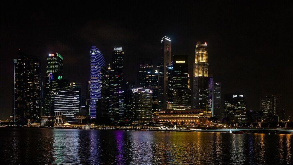 Singapore's downtown skyline lit up at night across Marina Bay
