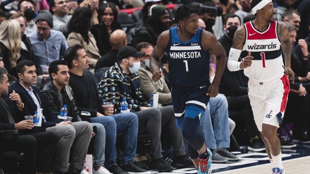 Anthony Edwards in a navy Minnesota Timberwolves No. 1 jersey running up the court during a game in Washington
