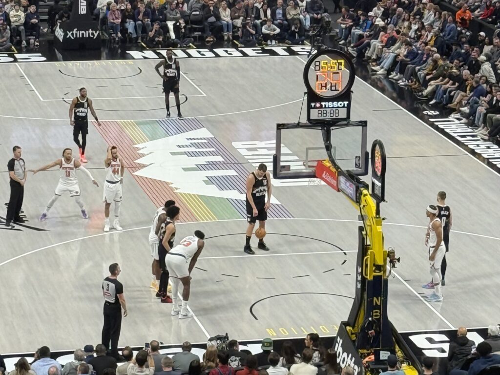Nikola Jokic at the free-throw line against the New York Knicks at Ball Arena in Denver, with two referees watching