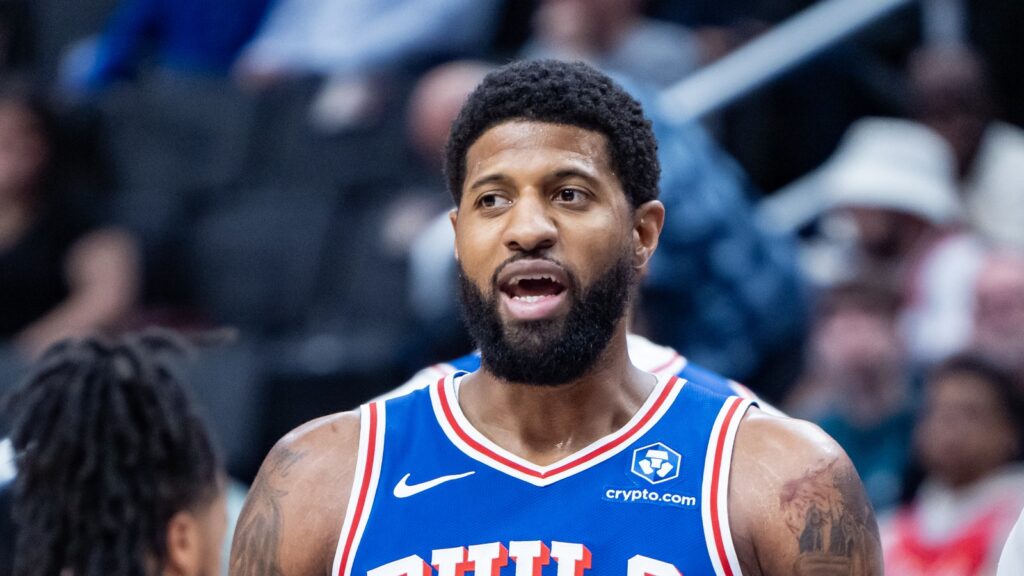 Paul George in a blue Philadelphia 76ers jersey on the court