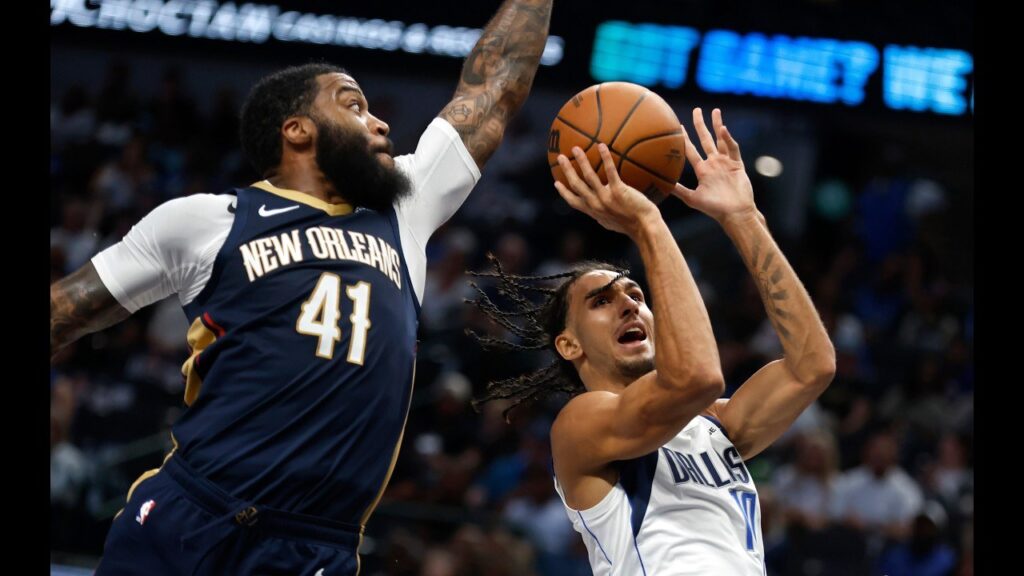 New Orleans Pelicans players on the floor during the preseason win at Dallas
