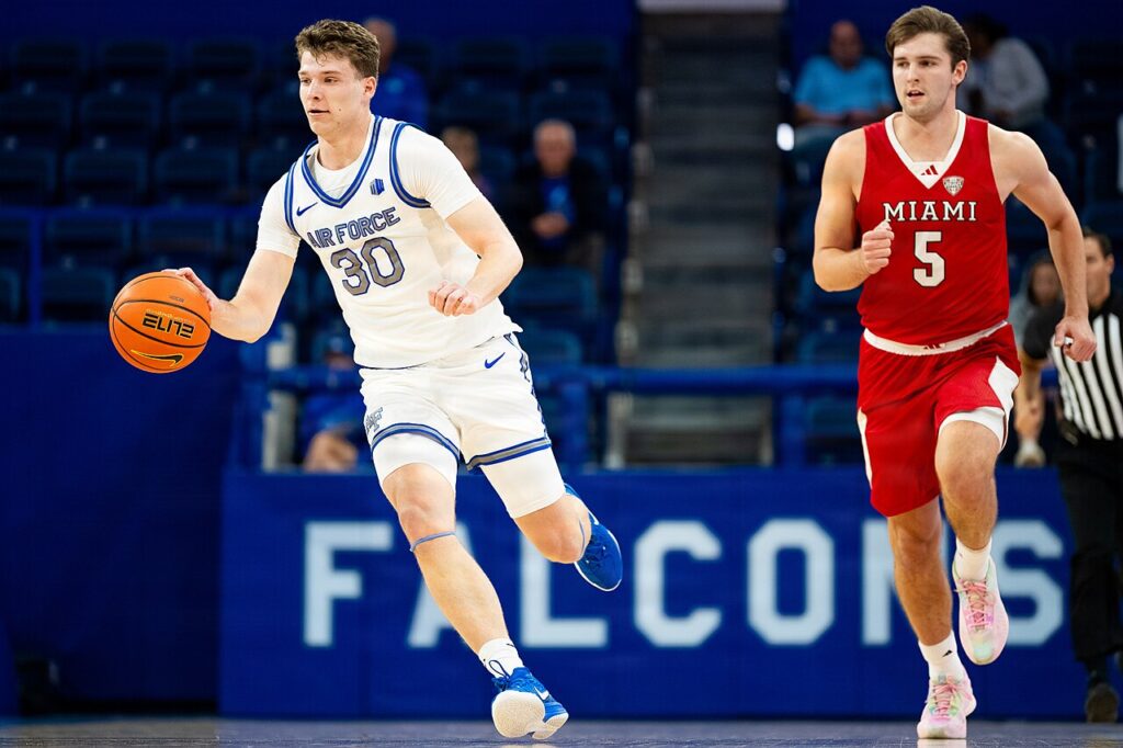 Peter Suder in Miami (Ohio)'s red No. 5 uniform alongside Air Force's Eli Robinson on November 15, 2025