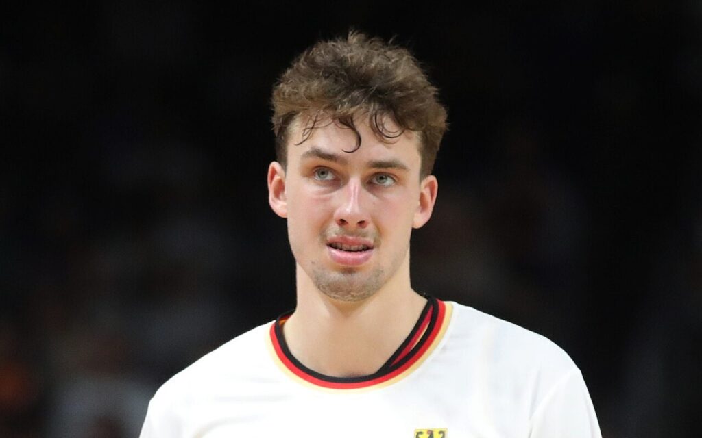 Franz Wagner in a white Germany jersey looks up during a game in Berlin