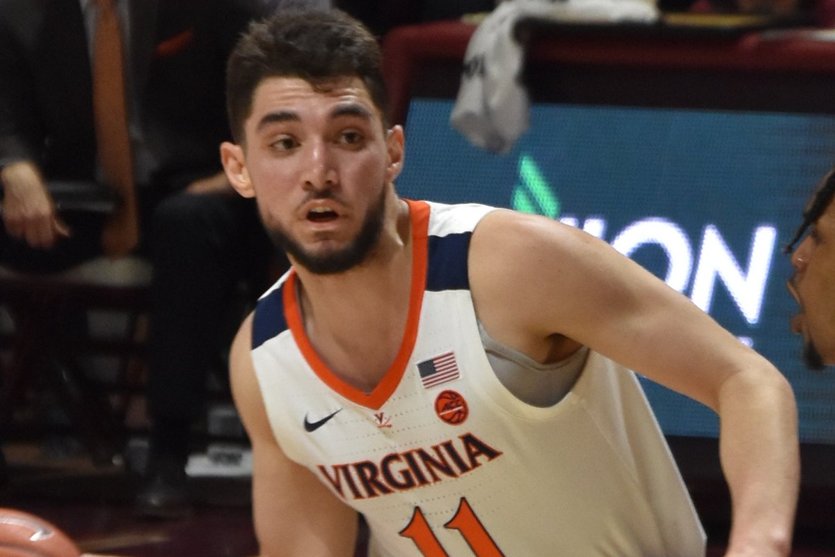 Ty Jerome in a white Virginia uniform during a college game in February 2019
