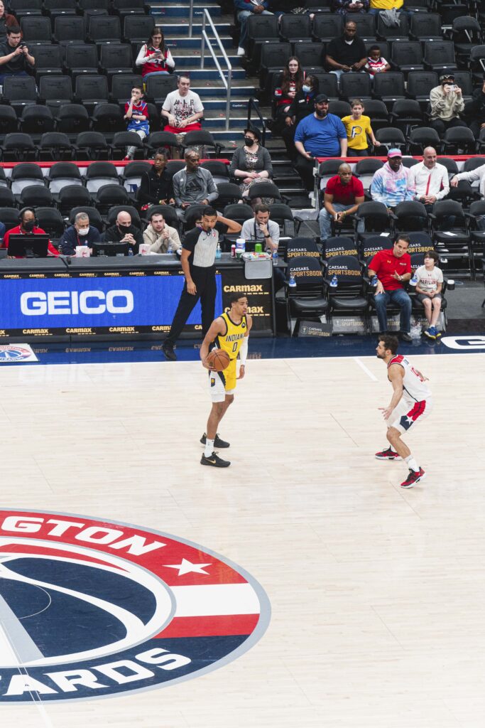 Tyrese Haliburton holding the basketball in Indiana’s yellow No. 0 uniform against Washington on March 6, 2022