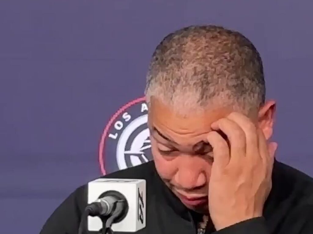 Clippers coach Tyronn Lue rubs his forehead at a postgame news conference at Intuit Dome