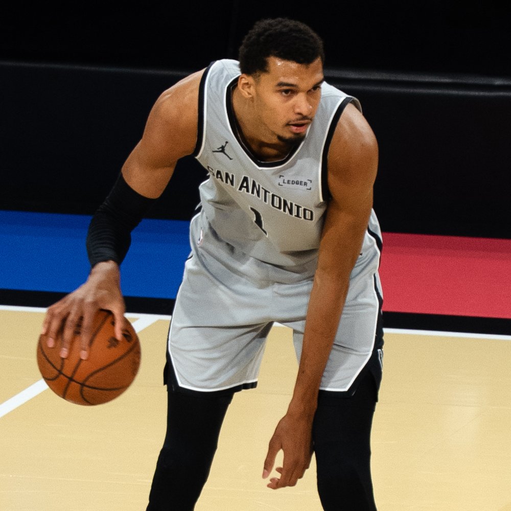Victor Wembanyama dribbling in a gray San Antonio Spurs uniform